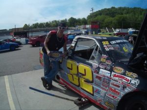 Man standing in front of stock car