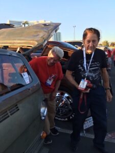 Two men looking at Jack Gilbert Jr.'s Chevy Van
